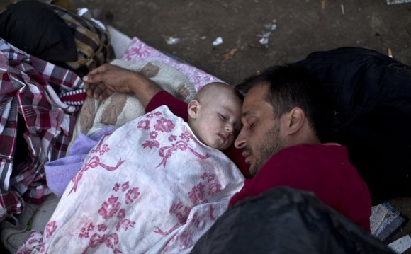 Migrants from Syria sleep at a